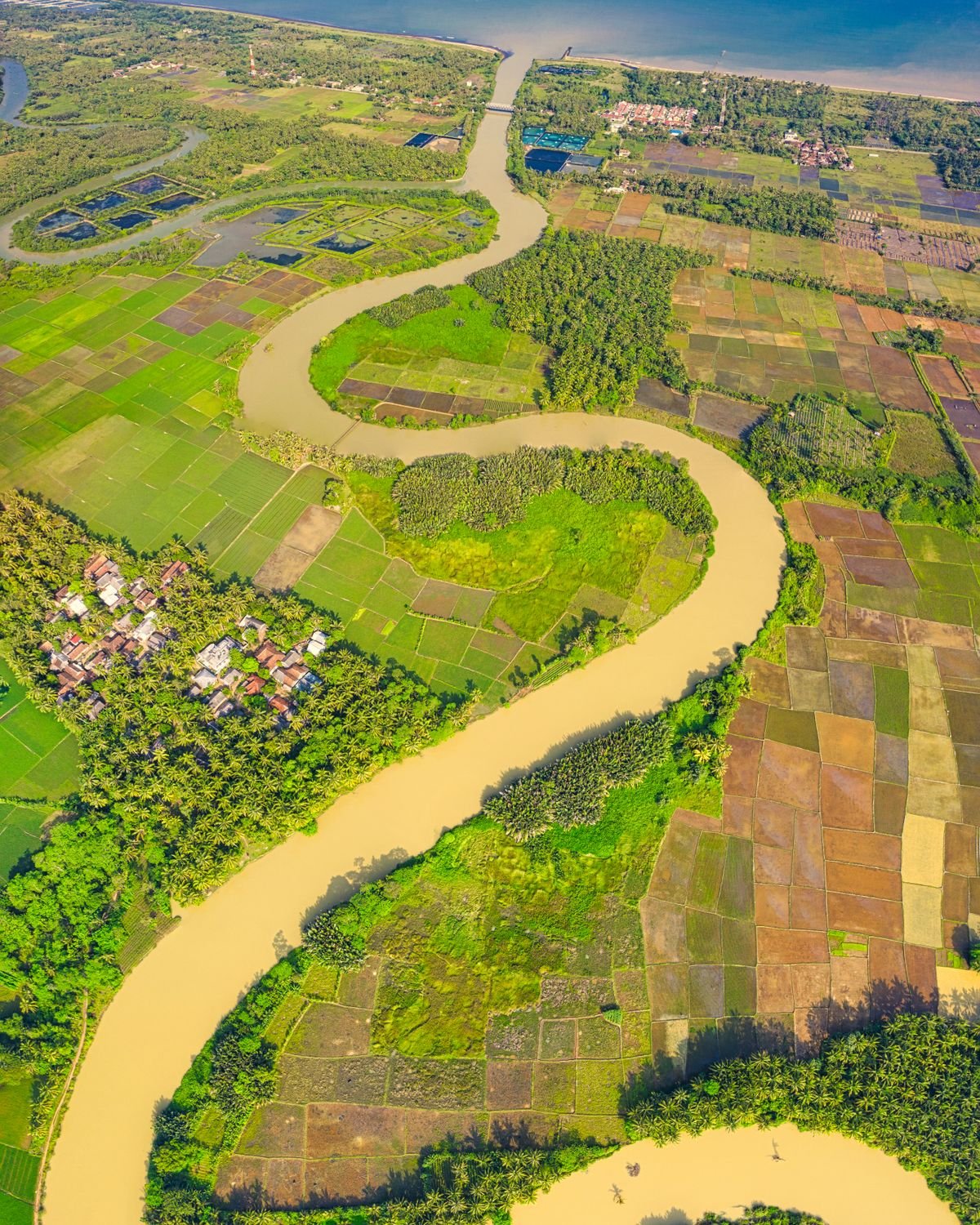 Aerial view of a river winding through farmland