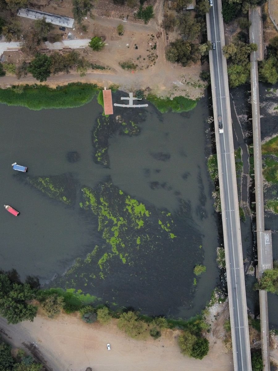 Aerial view of a river beside a bridge